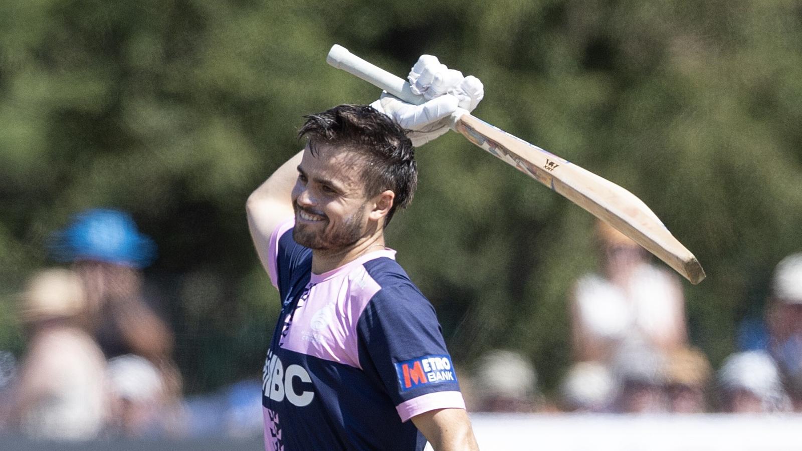 Middlesex's Joe Cracknell raises his bat after reaching a century against Sussex in the One-Day Cup