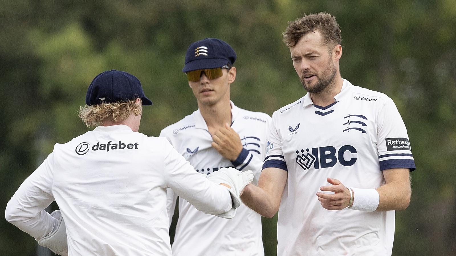 Middlesex's Tom Helm (R) celebrates a wicket with Harry Duke