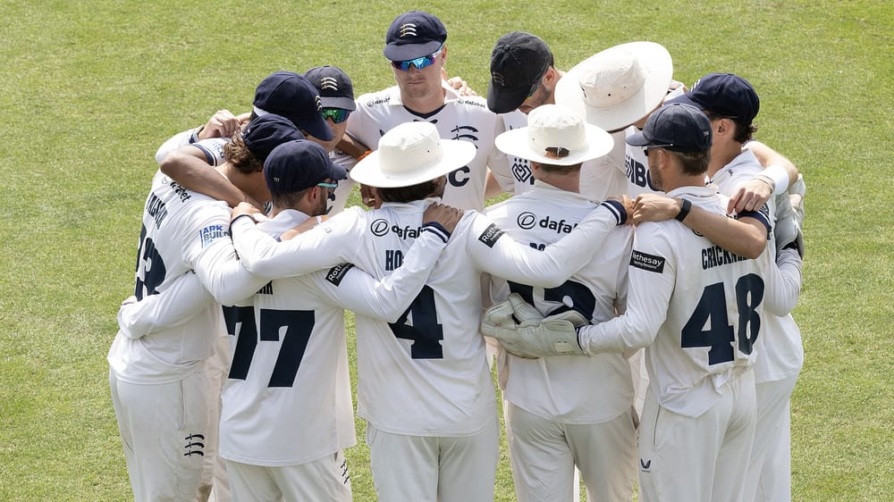 Middlesex's players gather for their team talk before going out to field against Kent at Canterbury