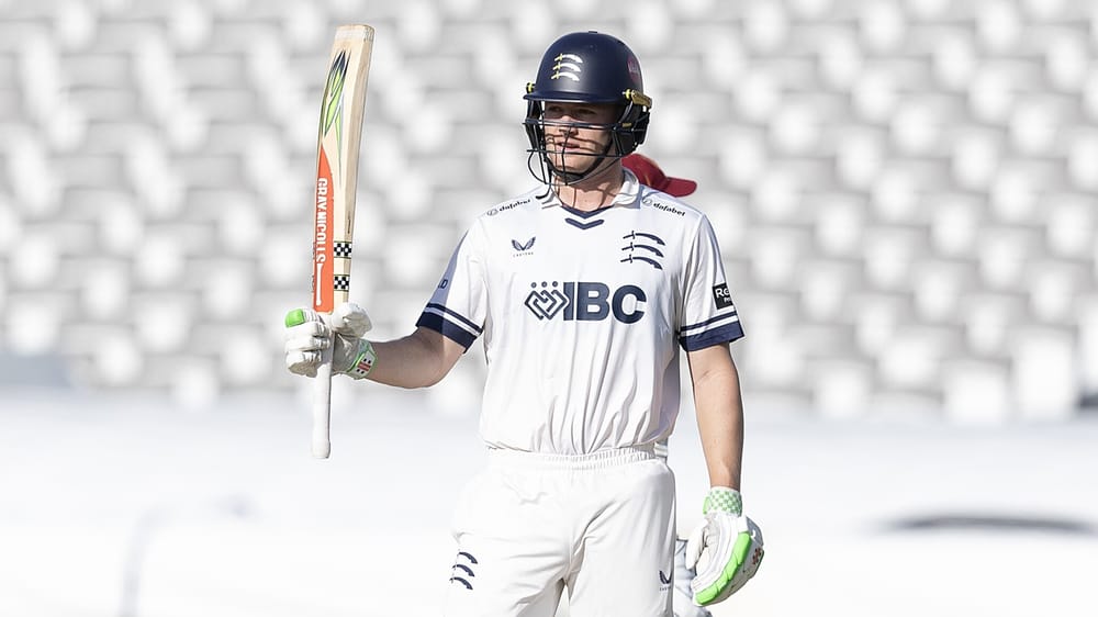 Middlesex's Ben Geddes raises his bat after reaching 50 against Northamptonshire at Lord's