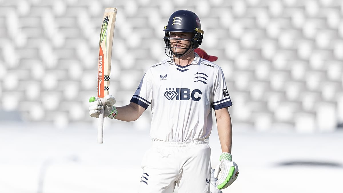 Middlesex's Ben Geddes raises his bat after reaching 50 against Northamptonshire at Lord's