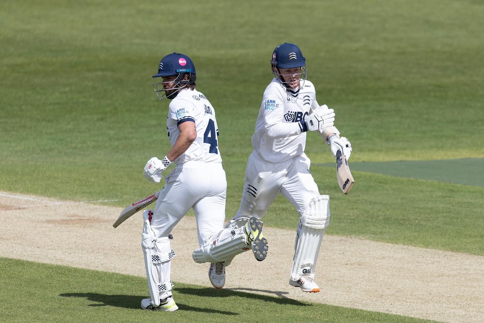 Max Holden (L) and Sam Robson cross during a run against Northamptonshire