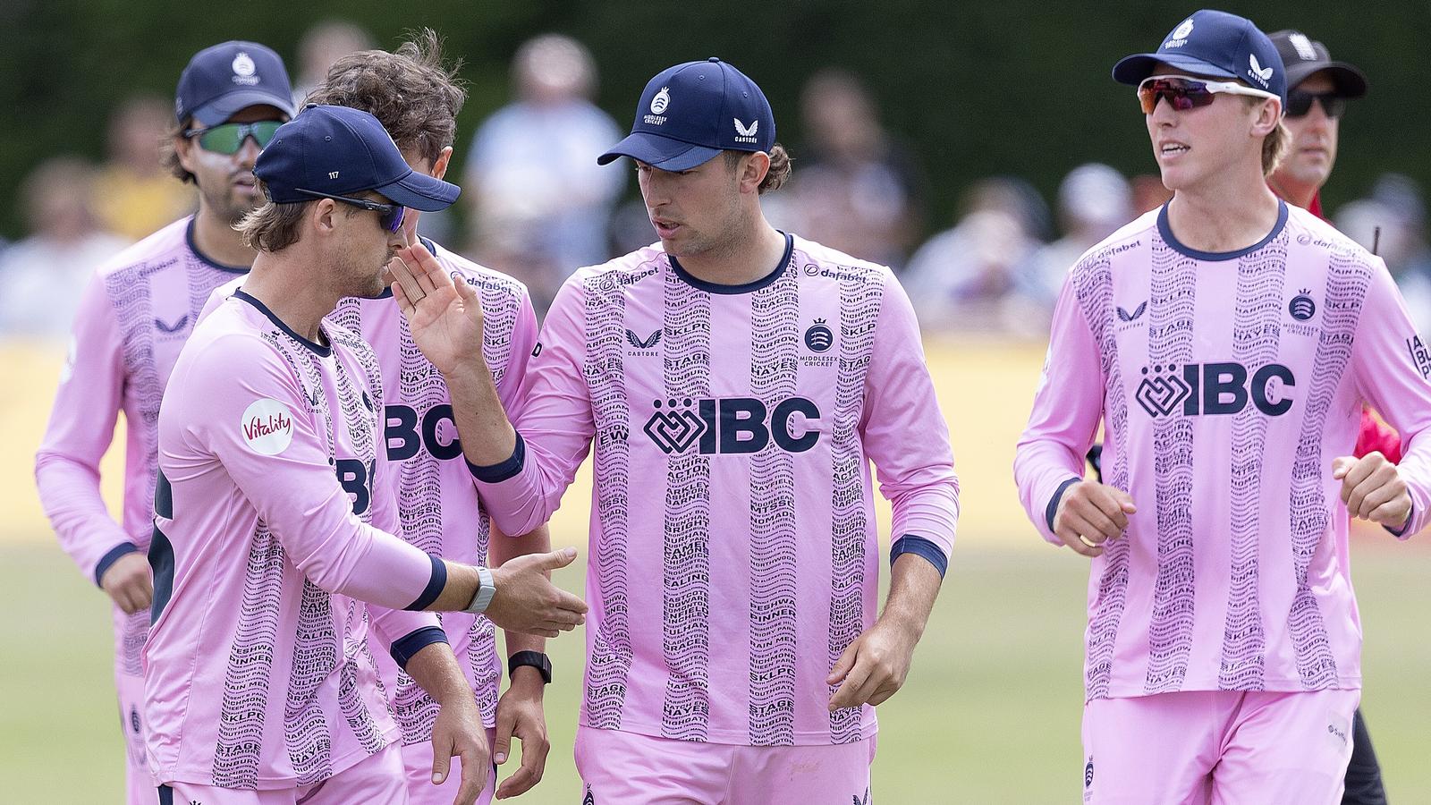 Middlesex's Leus du Plooy (L) and Josh de Caires celebrate the wicket of Durham's Graham Clark during the Vitality Blast