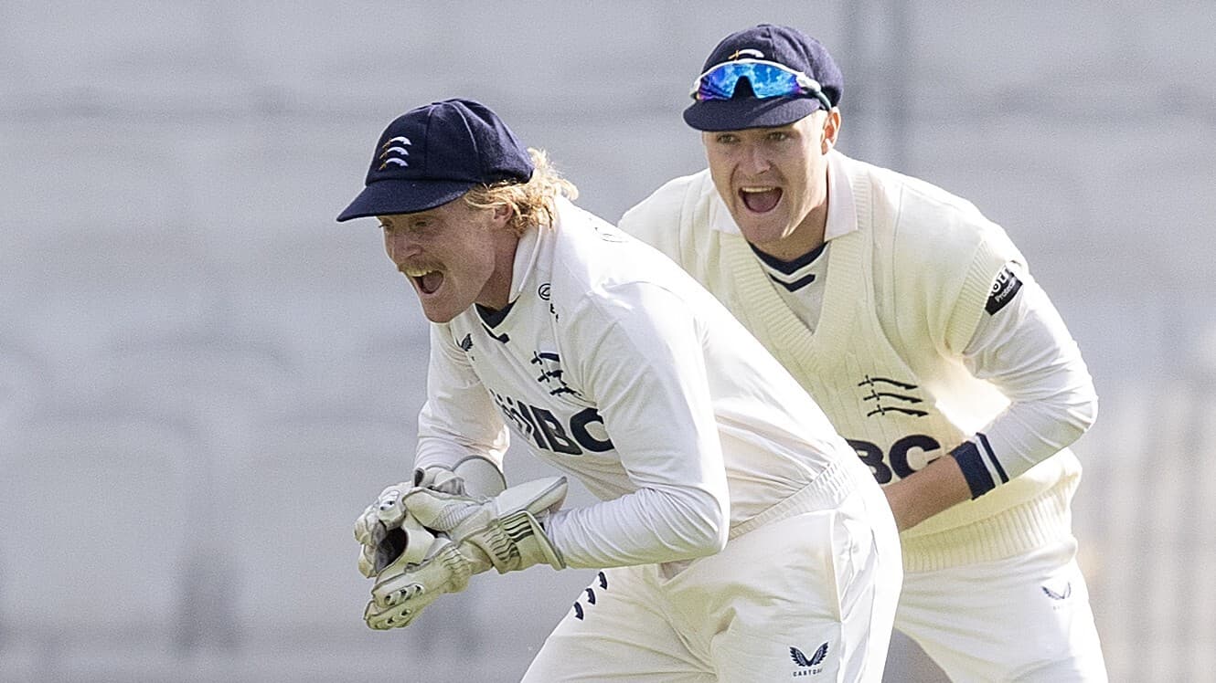 Middlesex wicketkeeper Harry Duke (L) takes a catch against Derbyshire, watched by team-mate Ben Geddes at slip