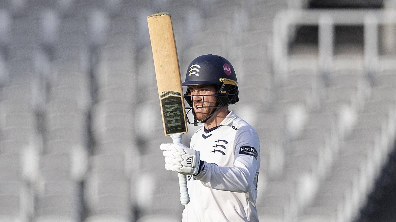 Middlesex's Ryan Higgins raises his bat after reaching a hundred against Northamptonshire at Lord's