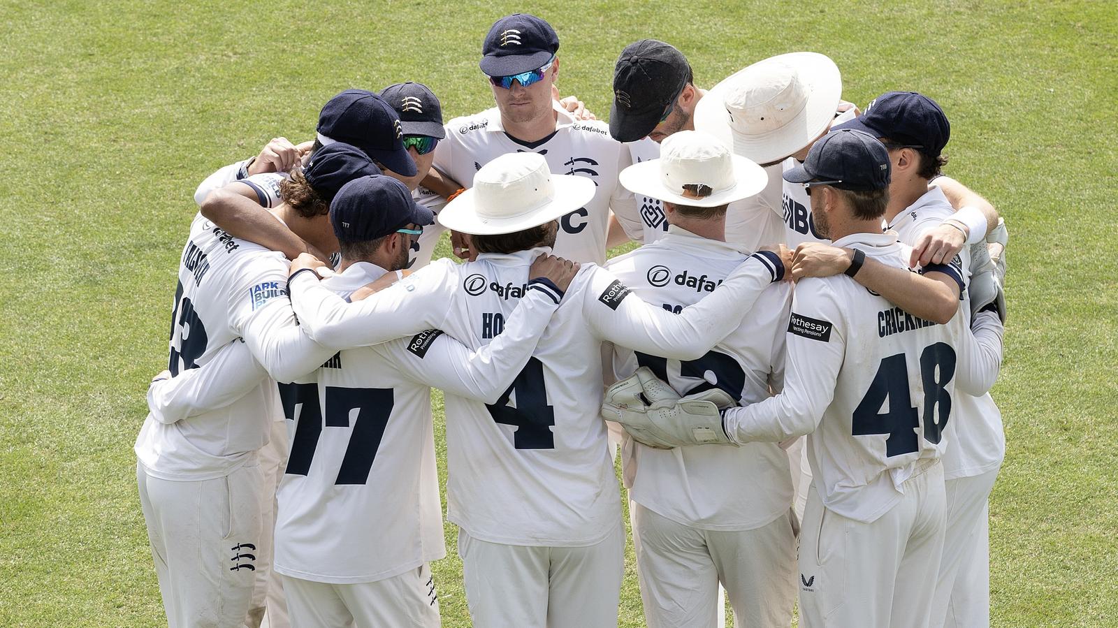 Middlesex's players gather for their team talk before going out to field against Kent at Canterbury