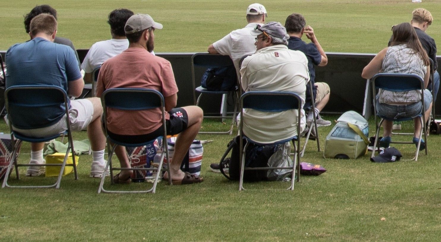 Spectators around the boundary edge at a county game