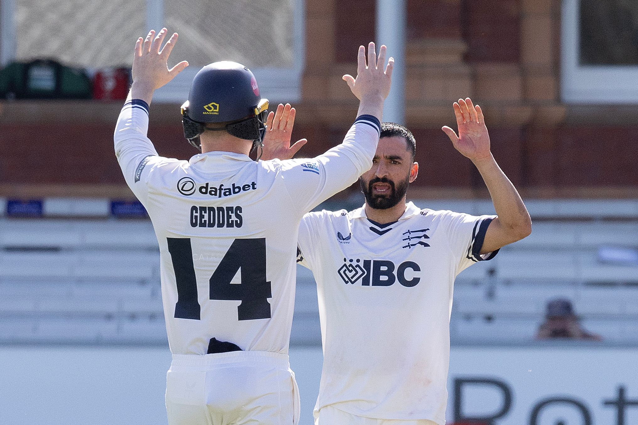 Zafar Gohar (R) celebrates a wicket with Ben Geddes